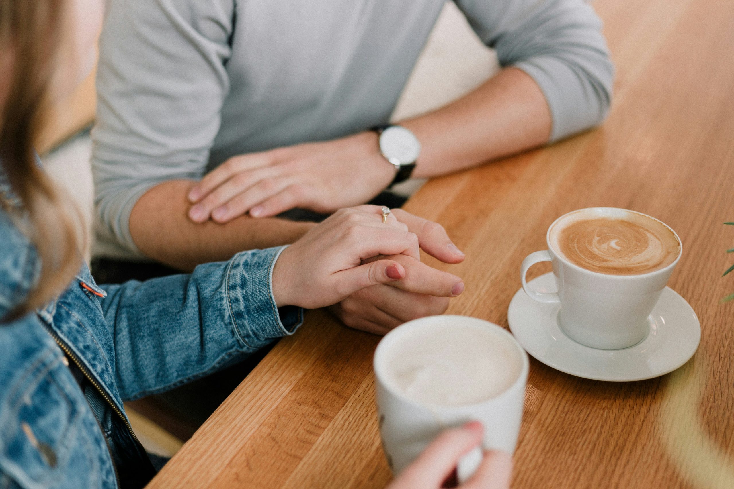 A couple engaging in a healthy repair attempt during a session with a Vancouver therapist, focusing on communication and apology languages.