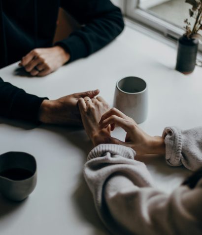 why-do-we-always-have-the-same-fight A couple holding hands after a recurring fight, wanting to feel safe