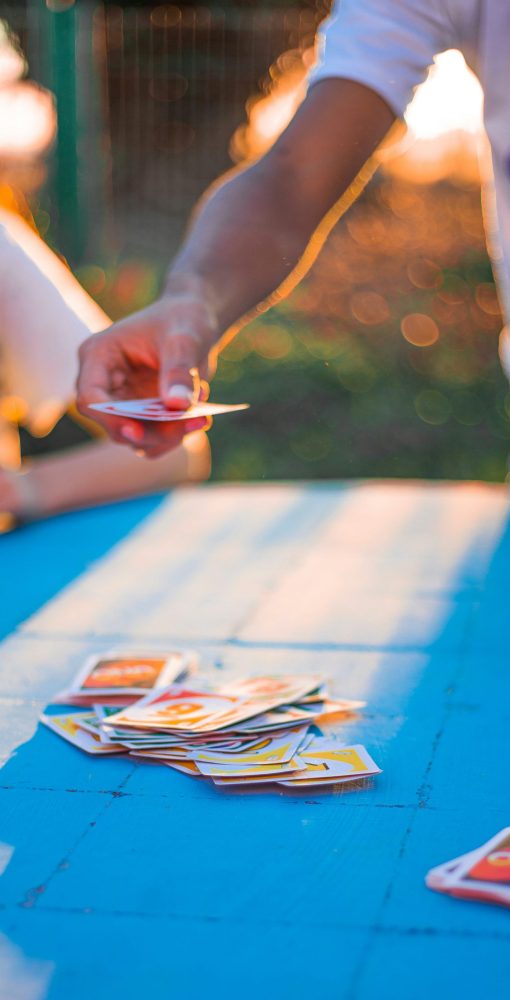 play-therapy-back-to-school-anxiety A parent plays uno with their anxious child as part of a play therapy exercise